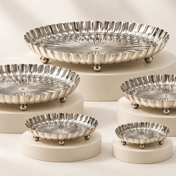 Five RAJAT silver-plated footed platters of different sizes displayed on white risers